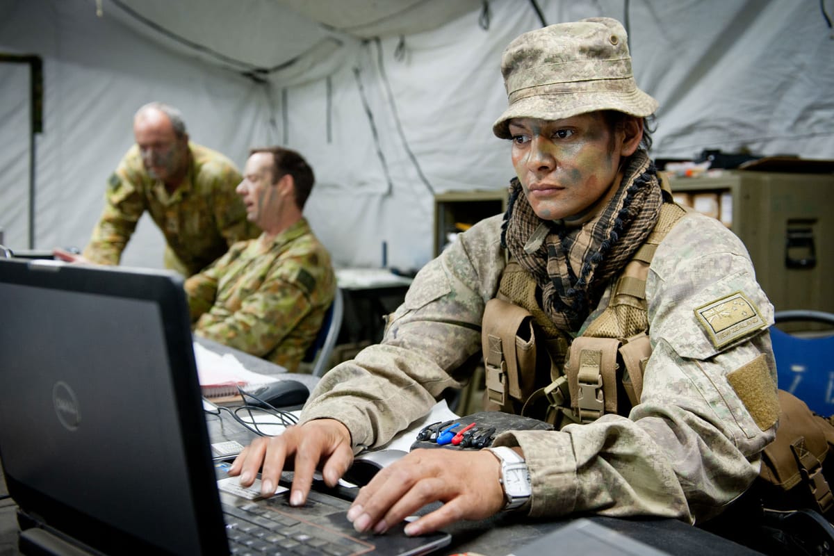 Soldiers with the laptop at a New Zealand millitary operation 