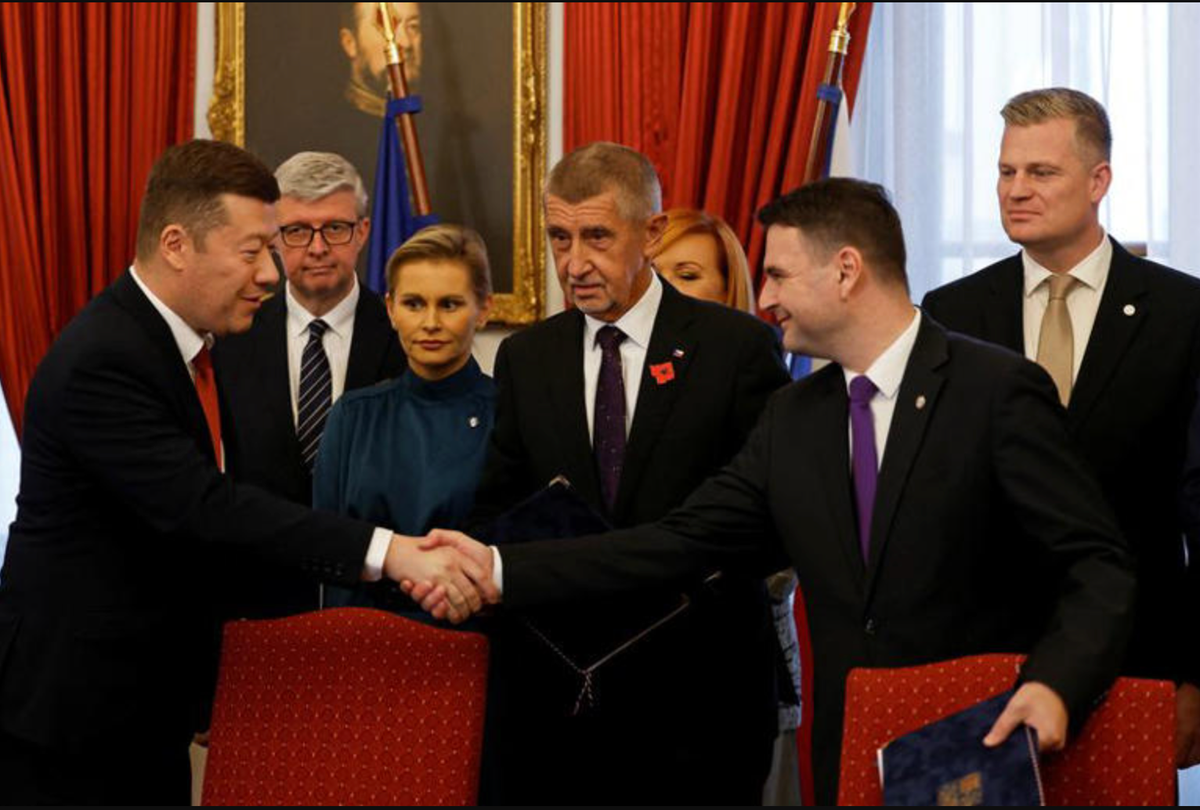 Leaders of the new Czech coalition shake hands after signing the coalition agreement in Prague on November 3, 2025