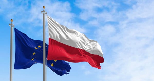 The flags of Poland and the European Union waving in the wind