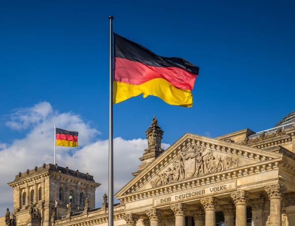 German flags waving in the wind at the Reichstag building, seat of the German Parliament